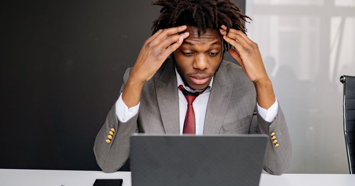 Frustrated business owner looking at laptop screen